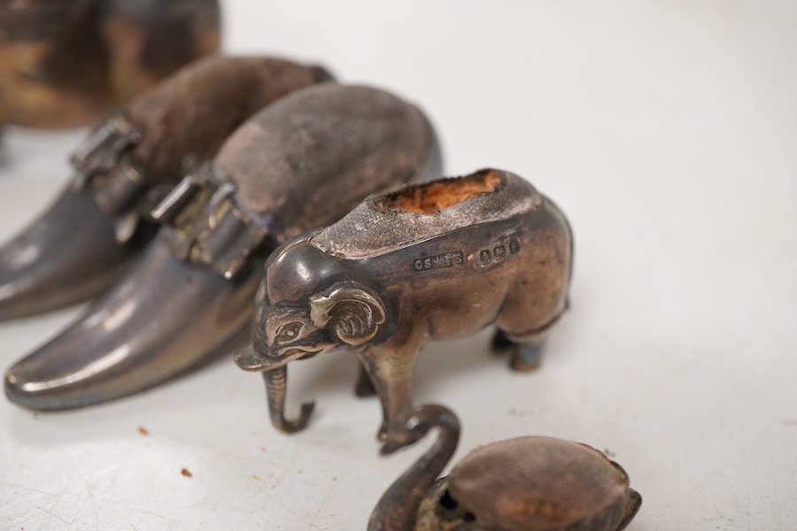 Five assorted novelty silver pin cushions, to include a model pig, maker's mark rubbed, Birmingham, 1903, length 67mm, two model shoes by Adie & Lovekin, a small elephant by Saunders & Shepherd, Birmingham, 1905 and a ti